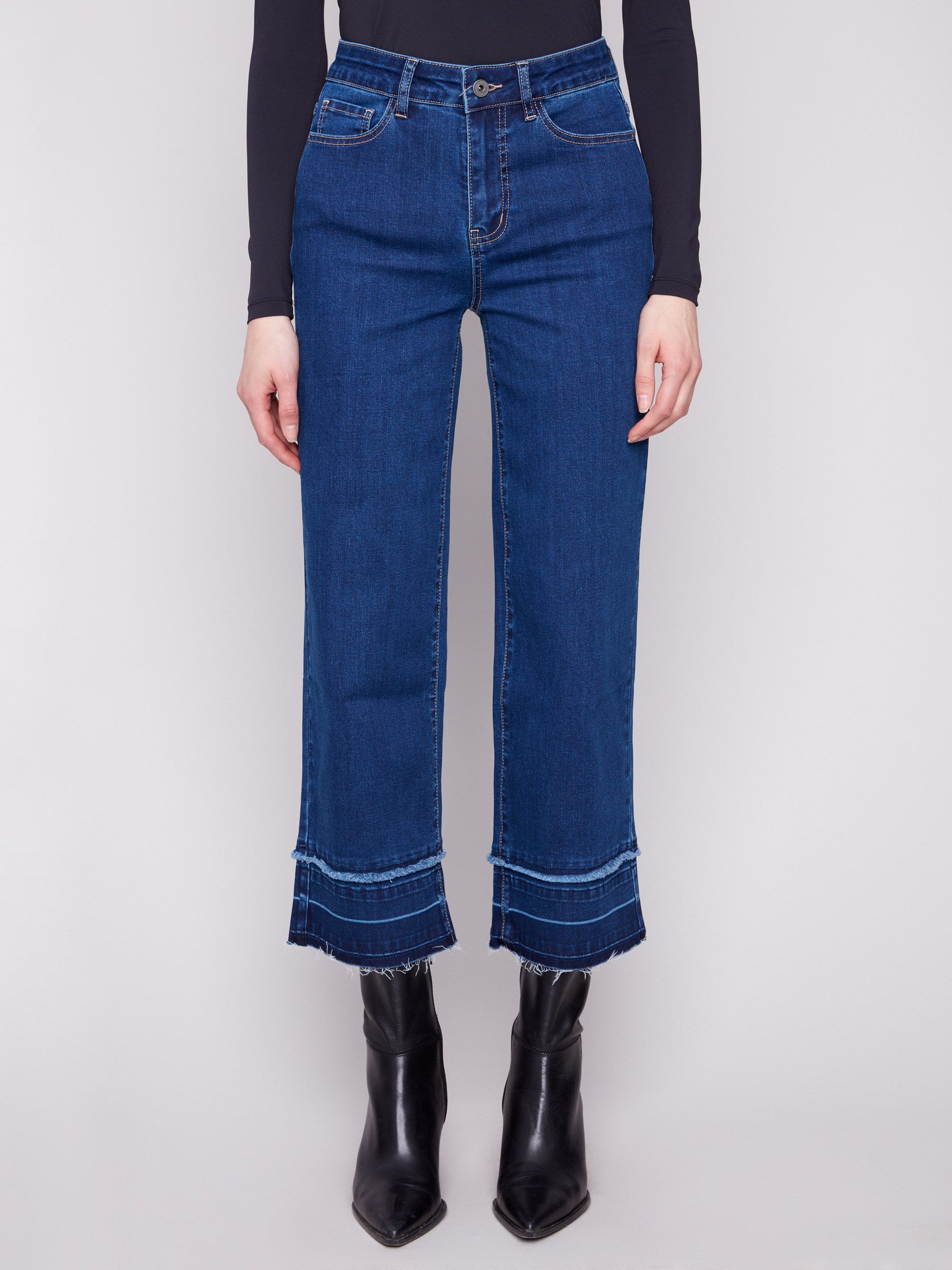 These jeans feature fringe details at the hem, adding a unique touch to your outfit by Charlie B.