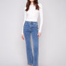 Medium blue jeans featuring a flare leg design and crafted from stretch denim, worn by a model, designed by Charlie B.