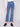 Jeans in medium blue with button details on side pockets and long length, styled by Charlie B.
