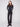 Black flare leg pants in long length featuring stretch twill fabric with stylish button accents by Charlie B.
