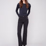 Black flare leg pants in long length featuring stretch twill fabric with stylish button accents by Charlie B.
