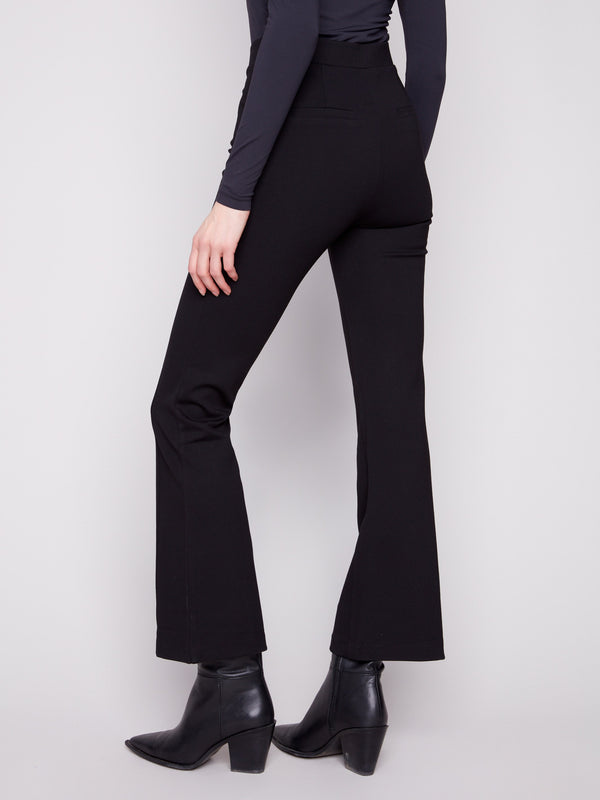 Chic black flare pants in stretch ponte material featuring faux back welt pockets and decorative button accents by Charlie B.