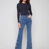 Medium blue jeans with a flare leg and floral embroidery, crafted in stretch denim for comfort by Charlie B.