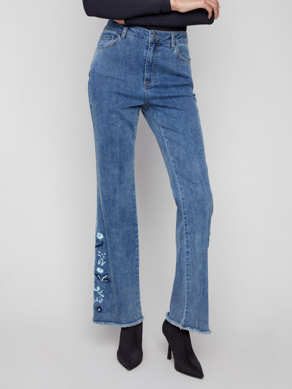 Stylish medium blue jeans with a regular rise and elegant floral embroidery detailing by Charlie B.
