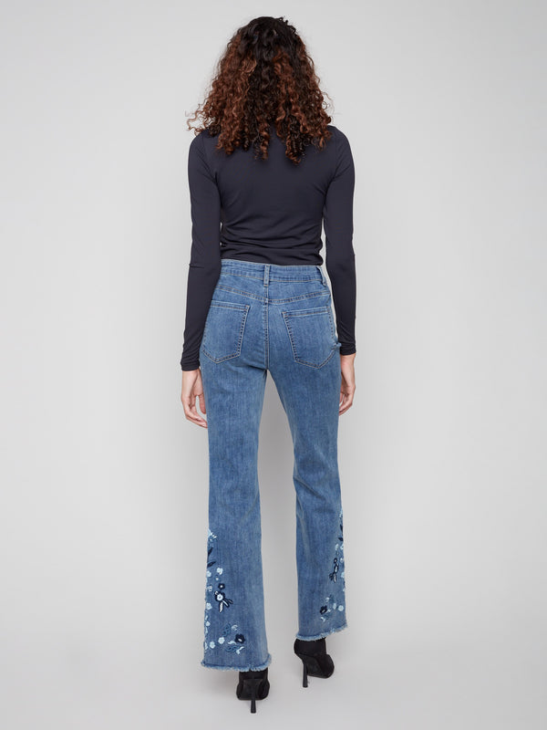 Floral embroidered flared jeans made from stretch denim, perfect for adding flair to any outfit by Charlie B.