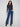 Indigo jeans with a flare fit and floral lace detailing. The stretch denim enhances comfort for everyday wear by Charlie B.
