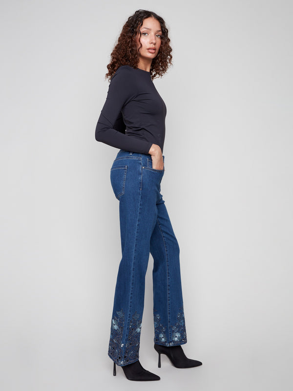 Stretch denim jeans in indigo, showcasing beautiful floral embroidery at the hem for a chic look by Charlie B.