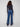 Embrace elegance with these long-length indigo jeans featuring exquisite floral lace embroidery at the hem by Charlie B.