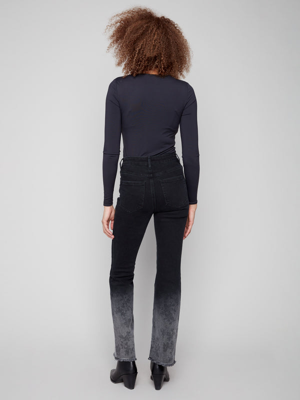 Featuring a unique washed frayed hem and classic five-pocket design in stretch denim by Charlie B.
