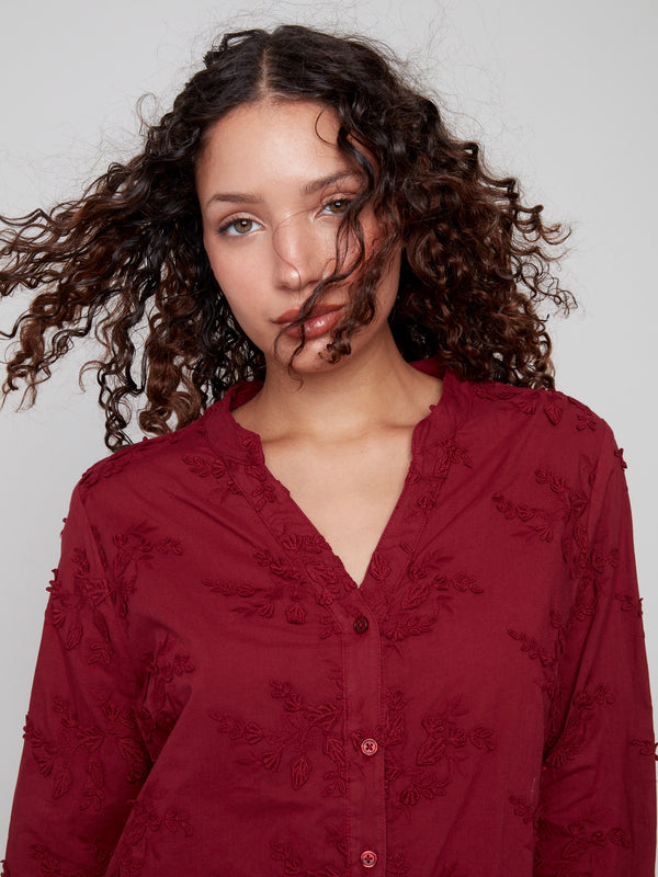 Stylish cabernet blouse showcasing detailed applique work, perfect for any occasion in a soft cotton fabric by Charlie B.