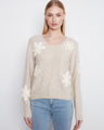 Almond V-neck sweater with drop shoulders, adorned with floral appliqués for a chic touch by Charlie B.