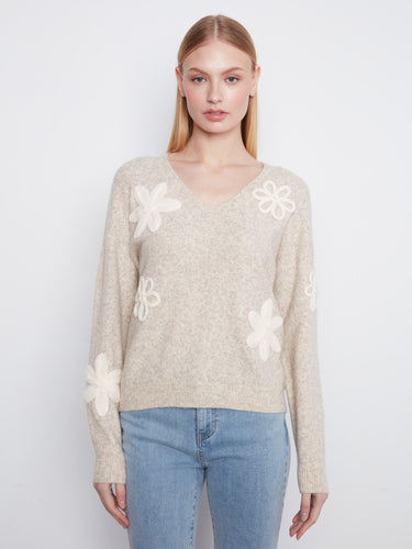 Almond V-neck sweater with drop shoulders, adorned with floral appliqués for a chic touch by Charlie B.