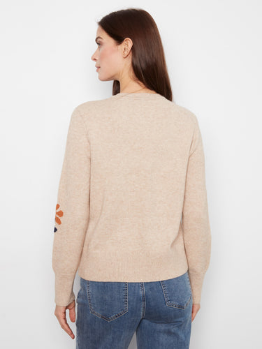 Chic heather-sand sweater showcasing ribbed cuffs and hem, complemented by a floral jacquard design by Charlie B.