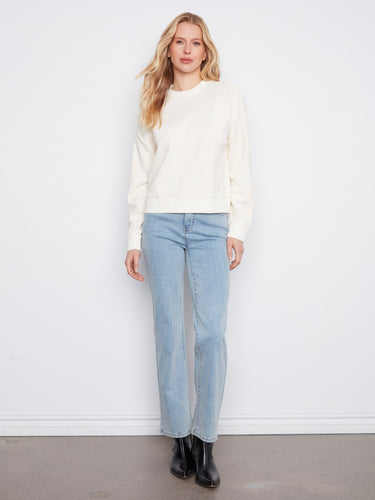 Chic buttercream sweatshirt with long sleeves and a floral flocking pattern, offering both comfort and style by Charlie B.