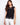 Black crochet top with a crew neckline, showcasing intricate floral patterns for a chic look by Charlie B.