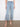 Cropped light blue jeans with a wide leg design and intricate floral cutouts at the hem by Charlie B.