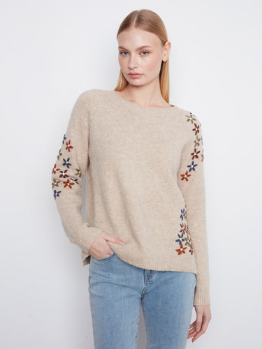 Beige sweater featuring long raglan sleeves adorned with colorful floral embroidery by Charlie B.