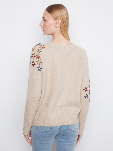Stylish crew neck sweater in beige with beautifully embroidered flowers on the sleeves for added flair by Charlie B.