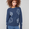 Denim sweater with drop shoulders, adorned with floral embroidery and ribbed details for a cozy feel by Charlie B.