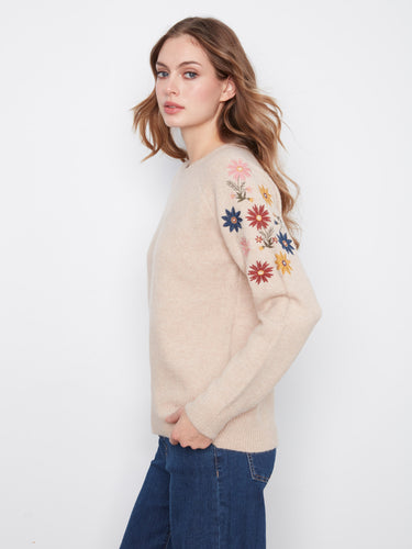 Crafted from a soft knit blend, this sweater ensures warmth while showcasing intricate floral designs. By Charlie B.