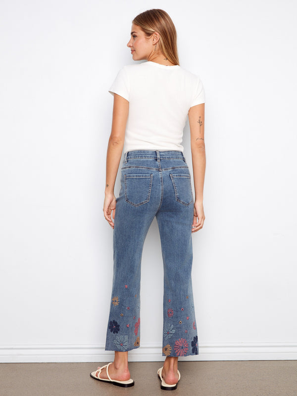 Crafted in stretch denim, these cropped jeans are adorned with colorful pixelated embroidery to elevate your wardrobe essentials by Charlie B.
