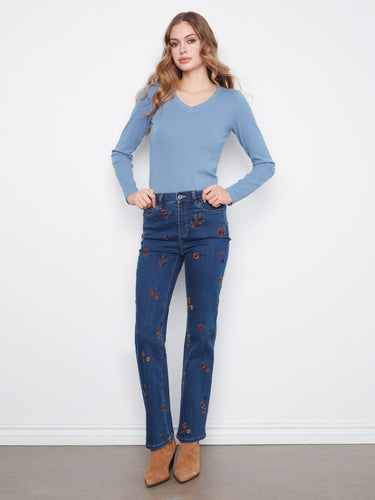 Denim jeans with vibrant floral embroidery, offering a stylish and artistic touch to your wardrobe. By Charlie B.