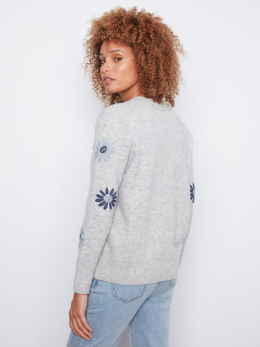 Elegant grey V-neck sweater showcasing exquisite floral embroidery, a wardrobe essential by Charlie B.