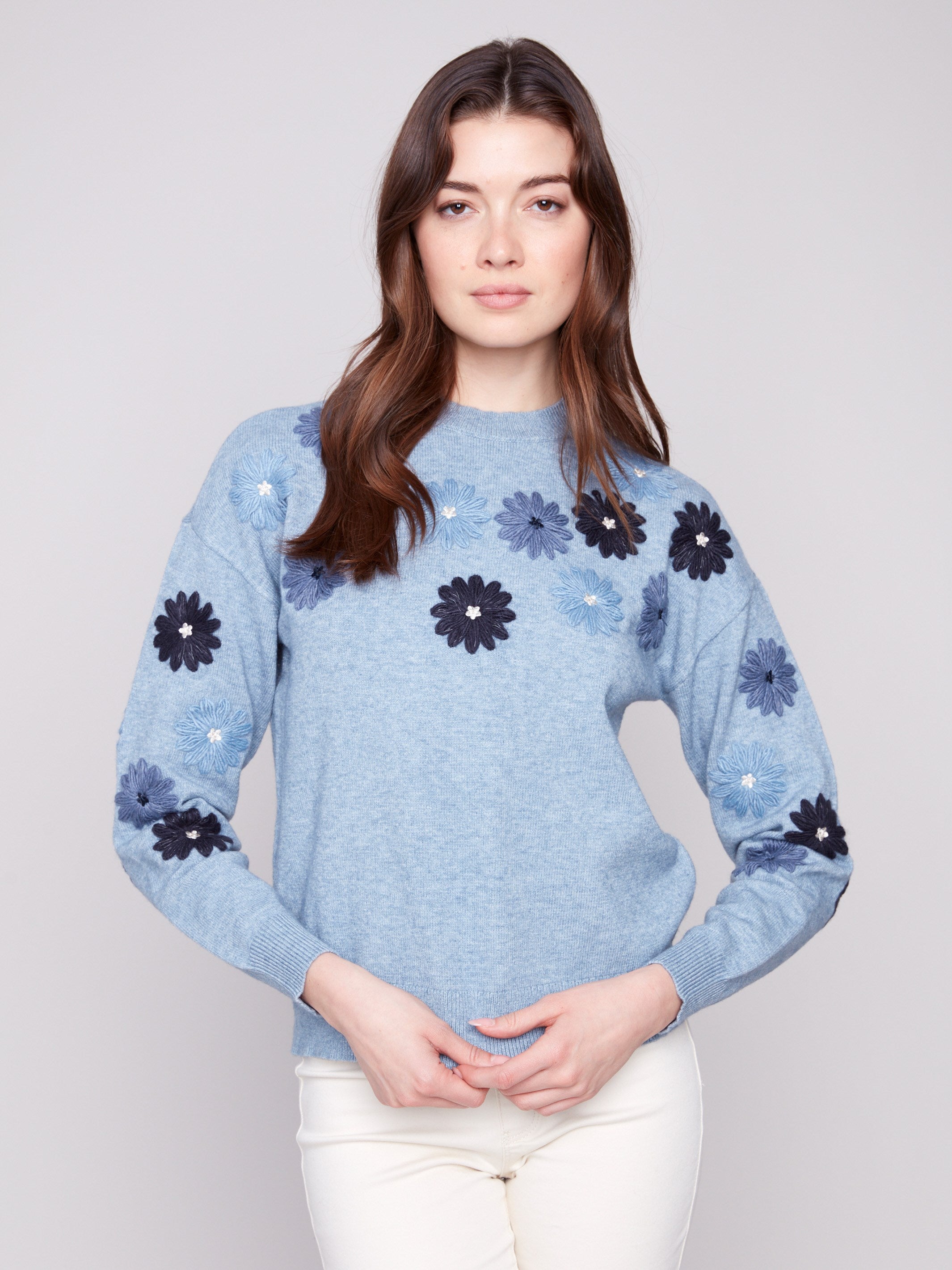 Denim sweater with floral embroidery, showcasing a relaxed fit and ribbed cuffs for comfort by Charlie B.