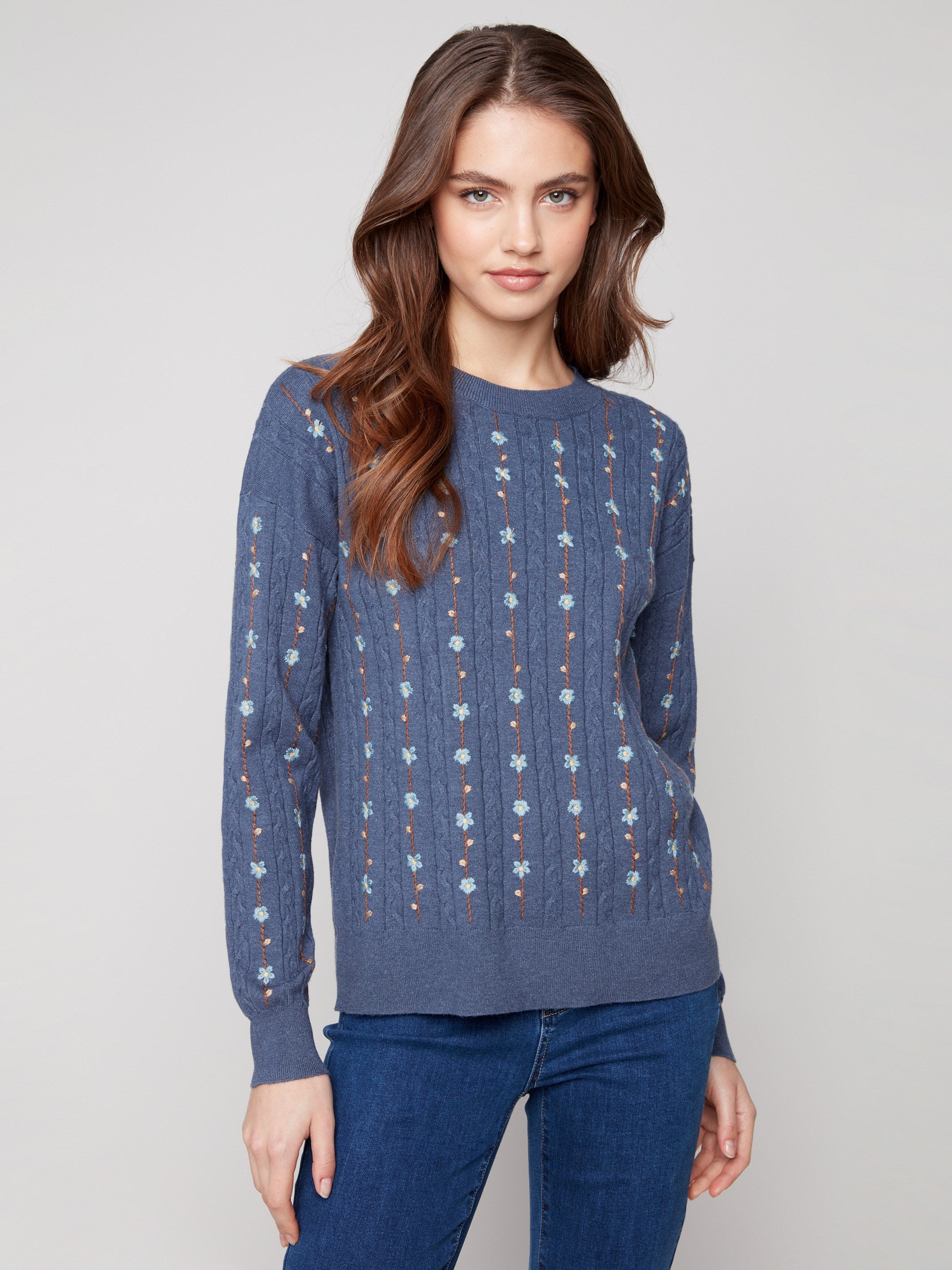 Knit sweater in tulip hue with intricate floral embroidery, showcasing a classic crew neck design by Charlie B.