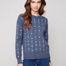 Knit sweater in tulip hue with intricate floral embroidery, showcasing a classic crew neck design by Charlie B.