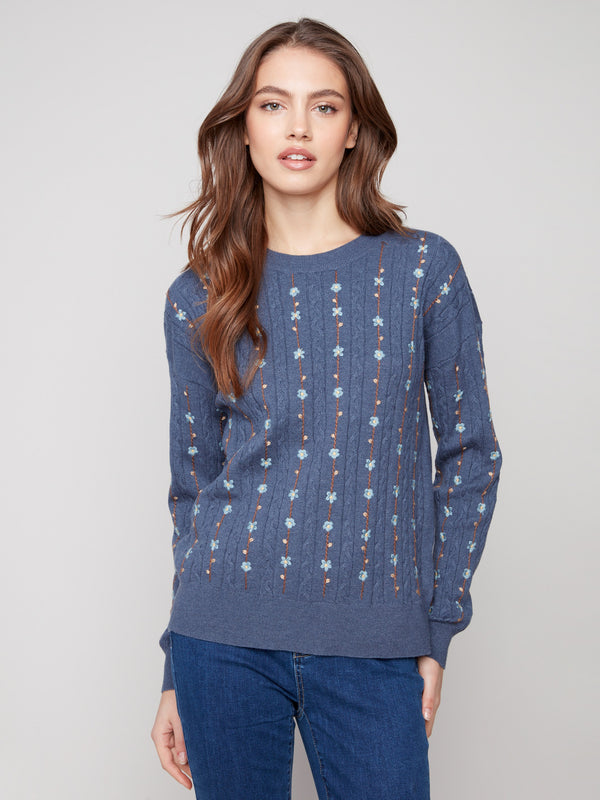 Stylish sweater crafted from soft fabric, highlighted by ribbed cuffs and beautiful floral detailing by Charlie B.