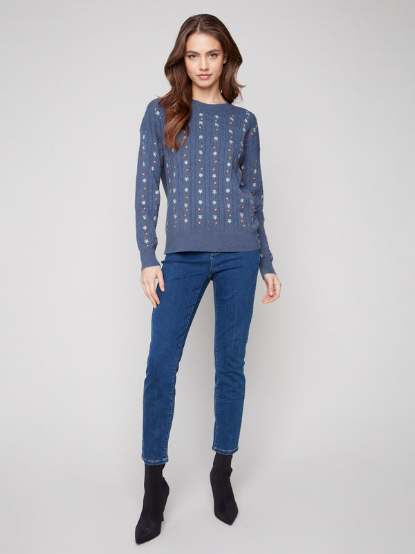 Sophisticated crew neck sweater with plush cable knit texture, perfect for adding elegance to any outfit by Charlie B.