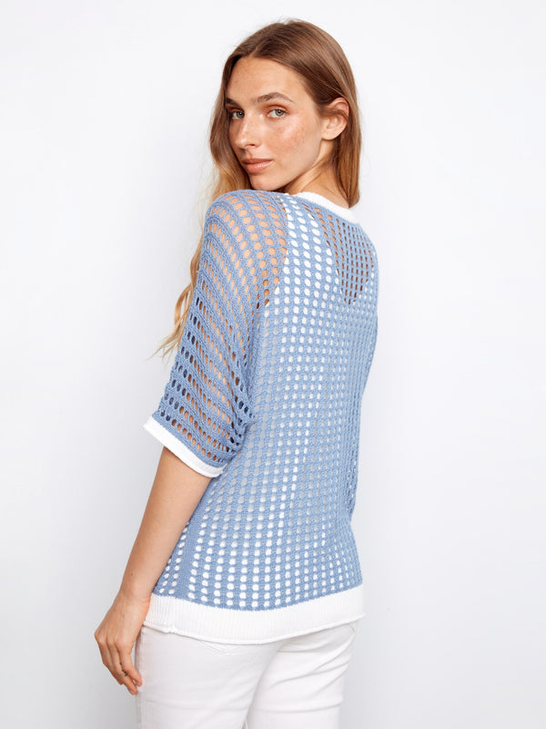 Stylish knit top in a relaxed fit, highlighted by its unique floral appliqué and fashionable design by Charlie B.