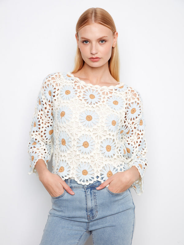 Floral crochet sweater with elegant boat neckline and delicate design. Perfect for a stylish day out by Charlie B.