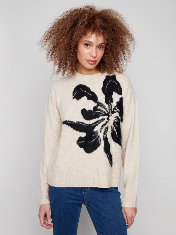 Beige sweater featuring a bold abstract flower pattern, perfect for adding flair to any outfit by Charlie B.