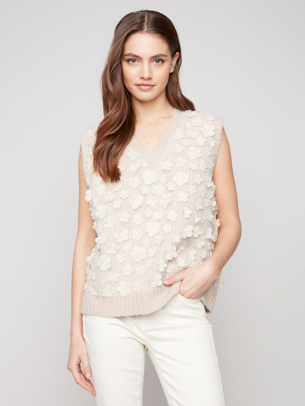 Sleeveless design with floral mesh adds elegance to this sweater vest by Charlie B.