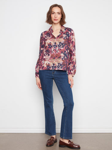 This floral blouse features a button-front closure for versatile styling options by Charlie B.