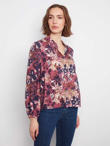 The vibrant floral pattern on this blouse brings color and charm to your wardrobe by Charlie B.