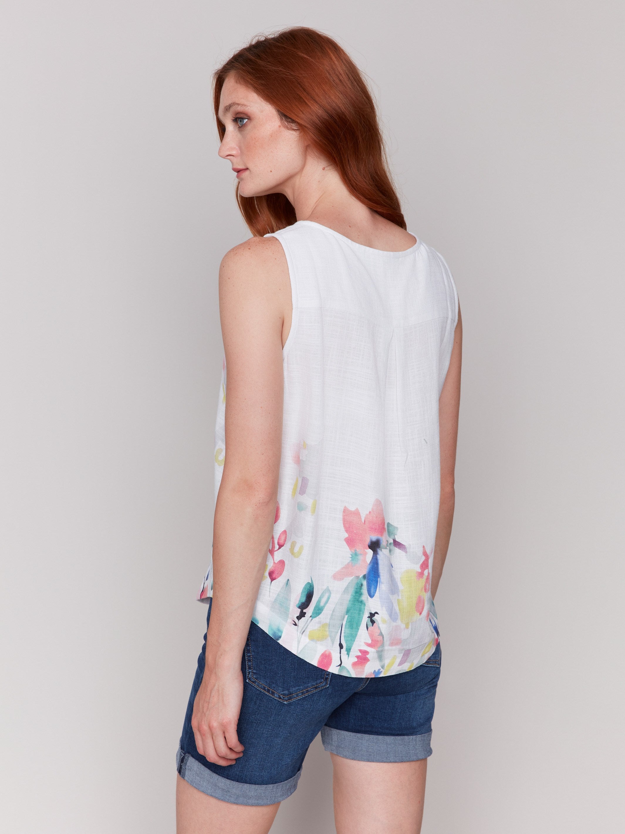 Sleeveless floral print top showcasing elegant style by Charlie B.