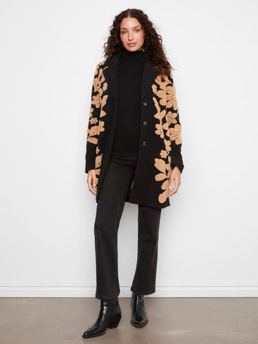 Chic button-front closure enhances this stylish coat adorned with floral designs. By Charlie B.