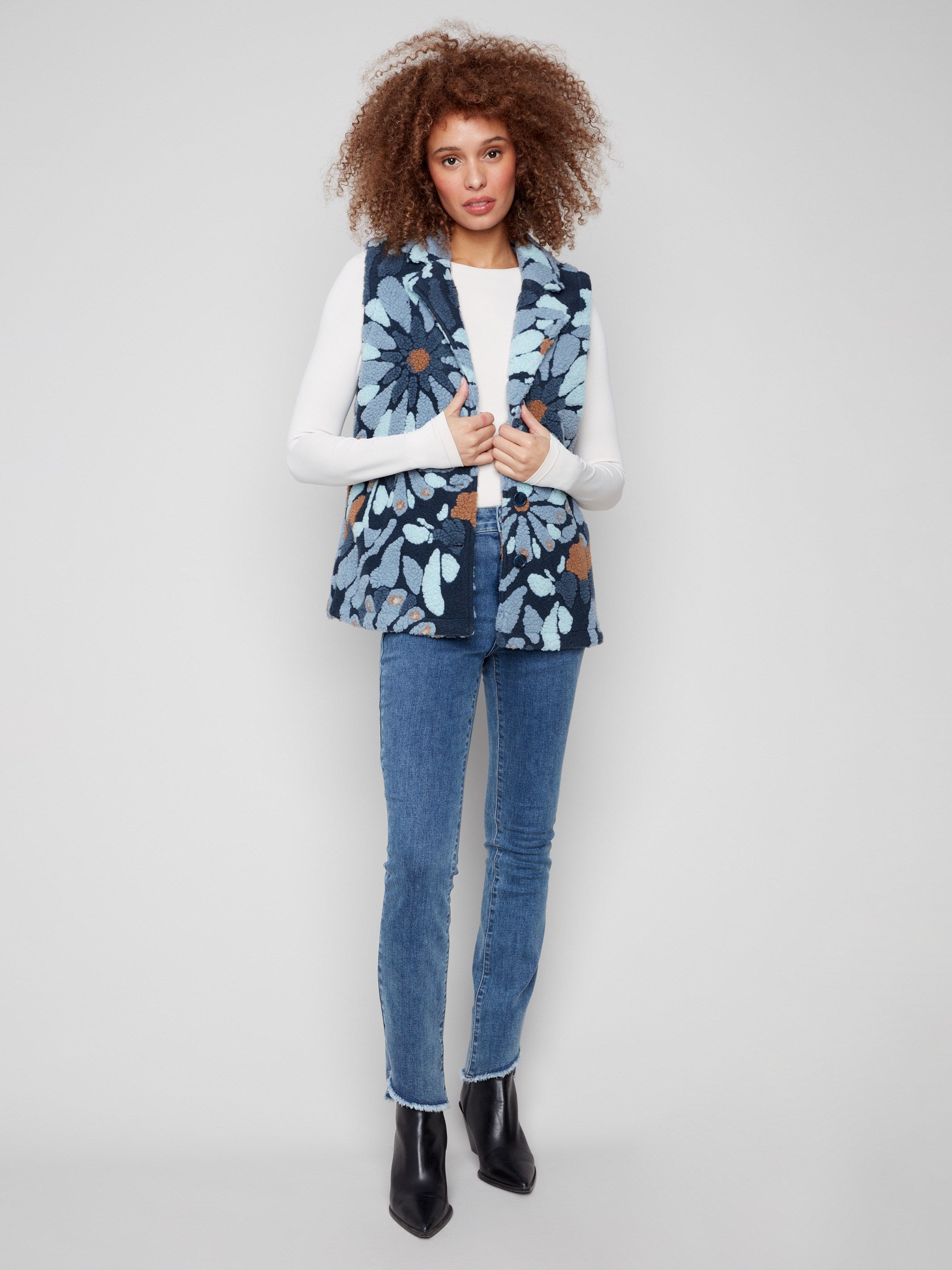 Floral Sherpa fleece vest in blue with handy two pockets, offering both style and functionality by Charlie B.