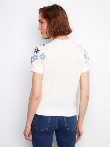 Elegant white top crafted from pure cotton, showcasing beautiful floral details on the sleeves for a chic look by Charlie B.