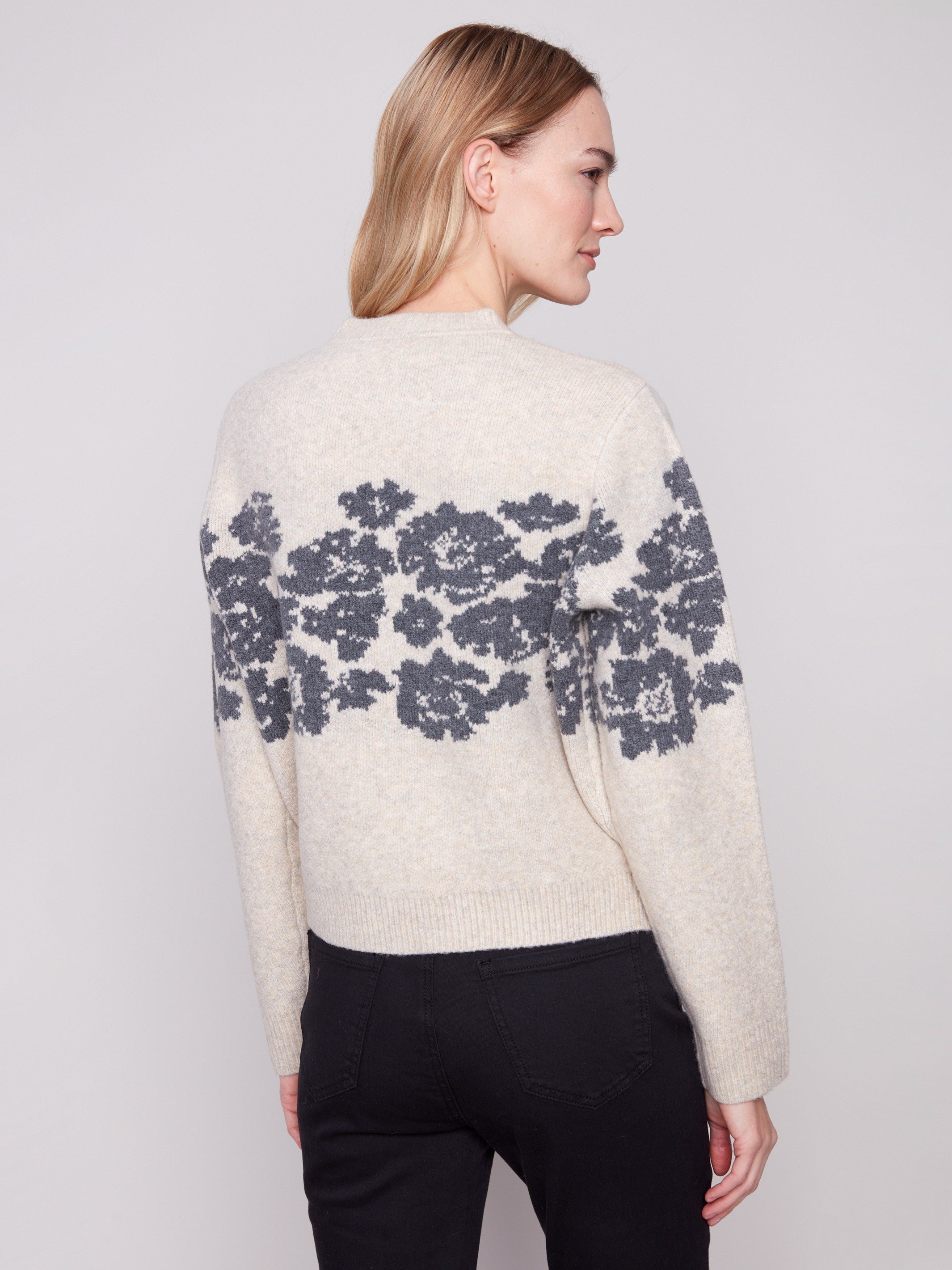 Chic knit cuffs add a touch of sophistication to this heather vanilla sweater with floral jacquard accents by Charlie B.