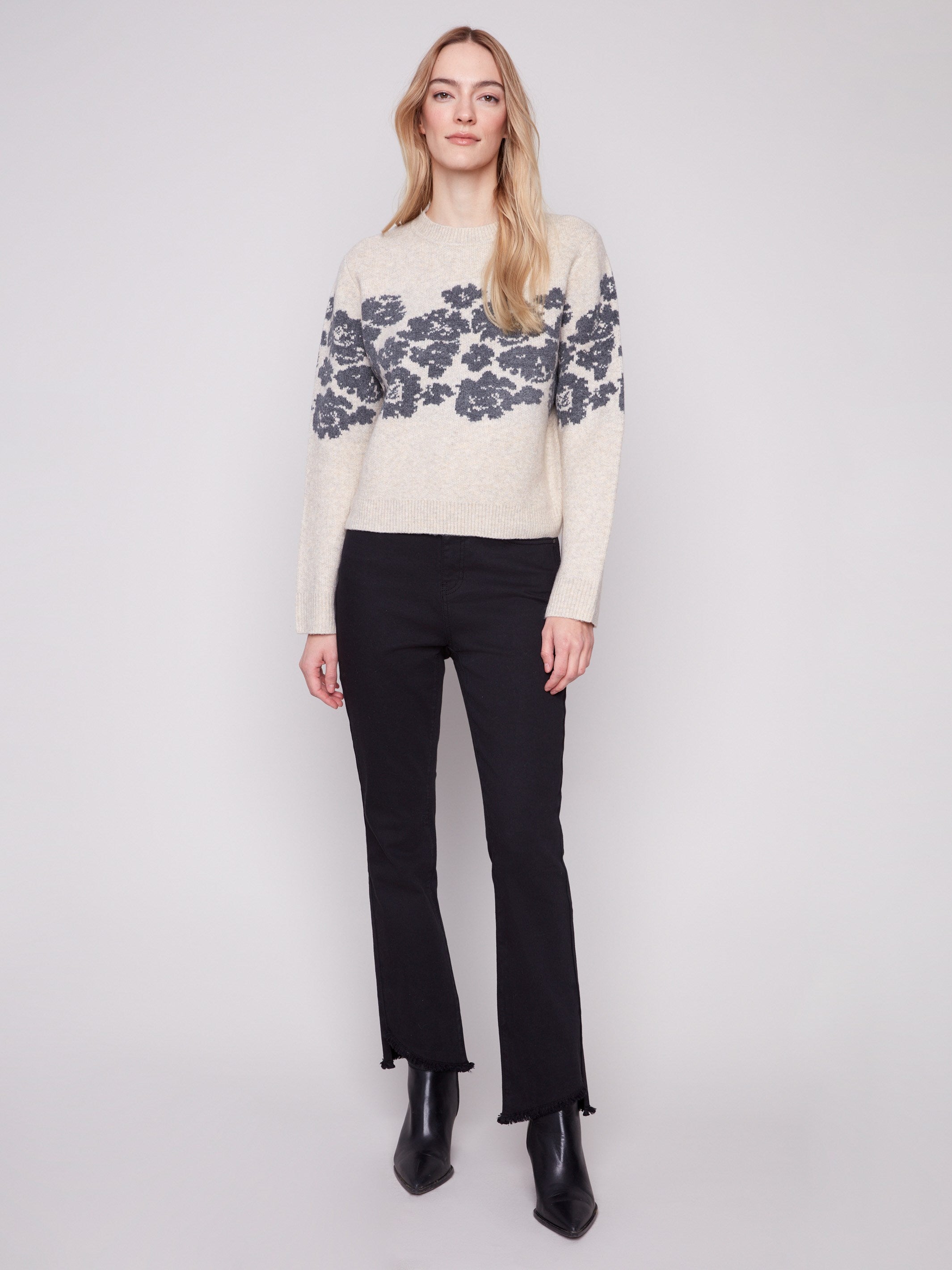Floral jacquard pattern adds elegance to this cozy vanilla sweater, designed for comfort and style by Charlie B.