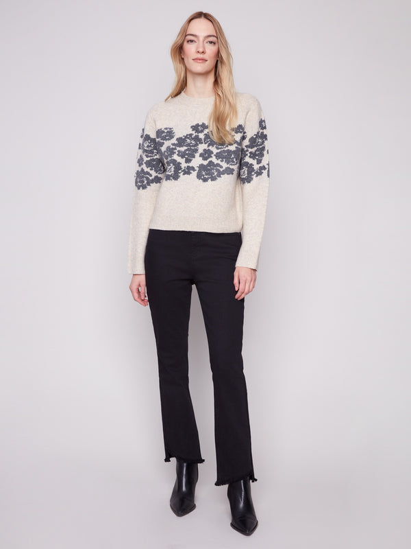 Floral jacquard pattern adds elegance to this cozy vanilla sweater, designed for comfort and style by Charlie B.