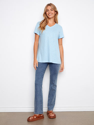 This light blue T-shirt features a foiled sheen, adding a touch of elegance to your everyday look. Short sleeves complete the style by Charlie B.