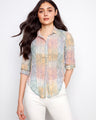 The shirt features a classic collar, perfect for versatile styling. Its elegant design is complemented by intricate patterns. By Charlie B.