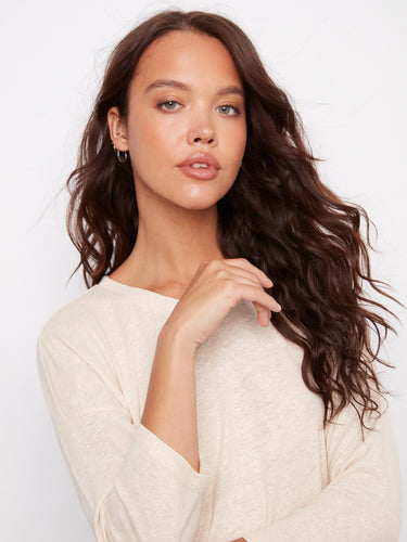 Featuring a subtle foiled effect, this stylish top adds a touch of shimmer. By Charlie B.