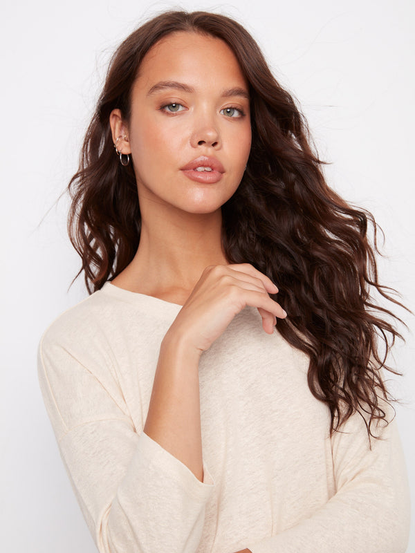 Featuring a subtle foiled effect, this stylish top adds a touch of shimmer. By Charlie B.