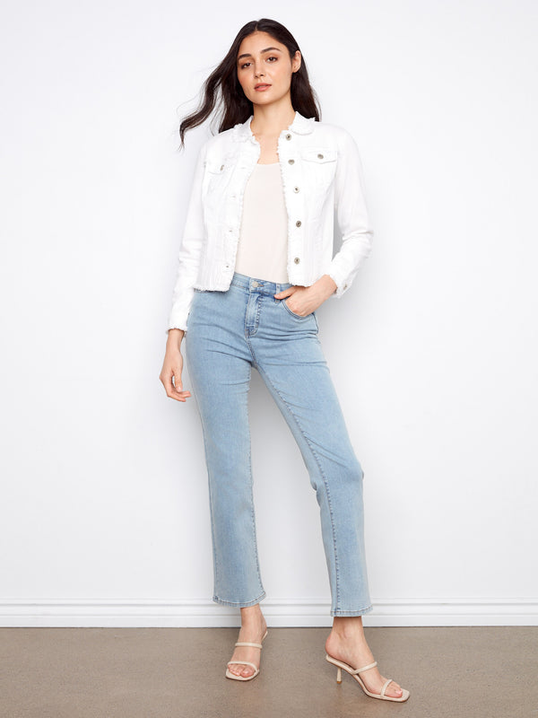 White jean jacket with button front and frayed details, offering a stylish twist to classic denim by Charlie B.